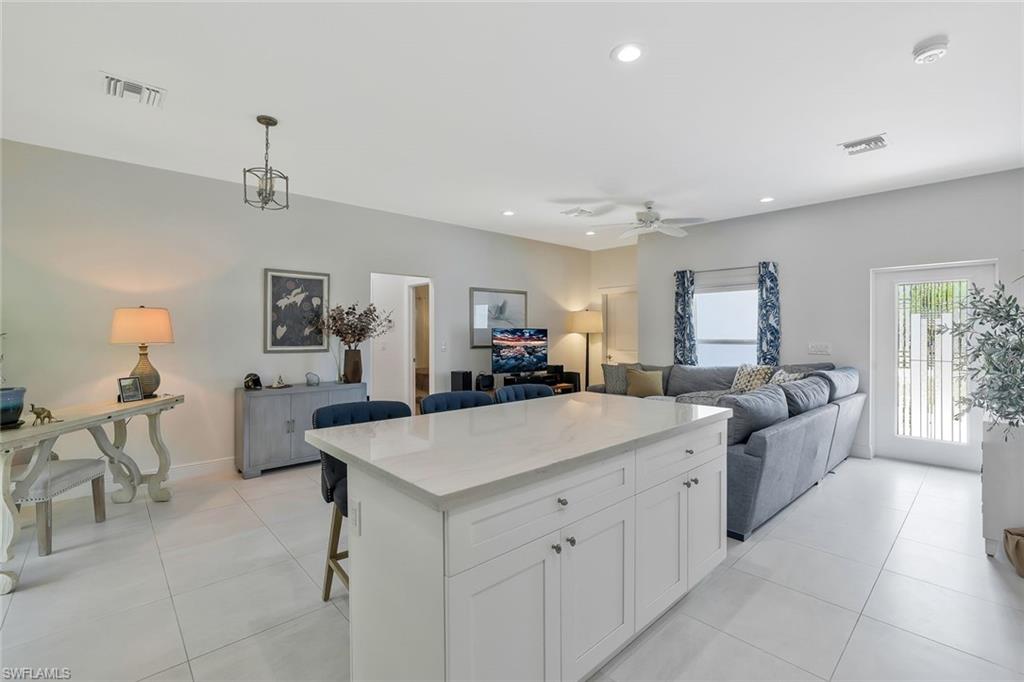 3892 14th Street North Naples, FL 34103 - Photo 19 of 19 a view of living room kitchen island a sink and a refrigerator