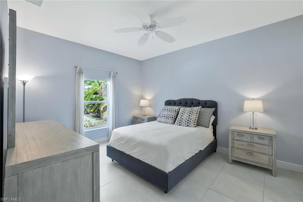 3892 14th Street North Naples, FL 34103 - Photo 7 of 19 a bedroom with a bed and a chandelier