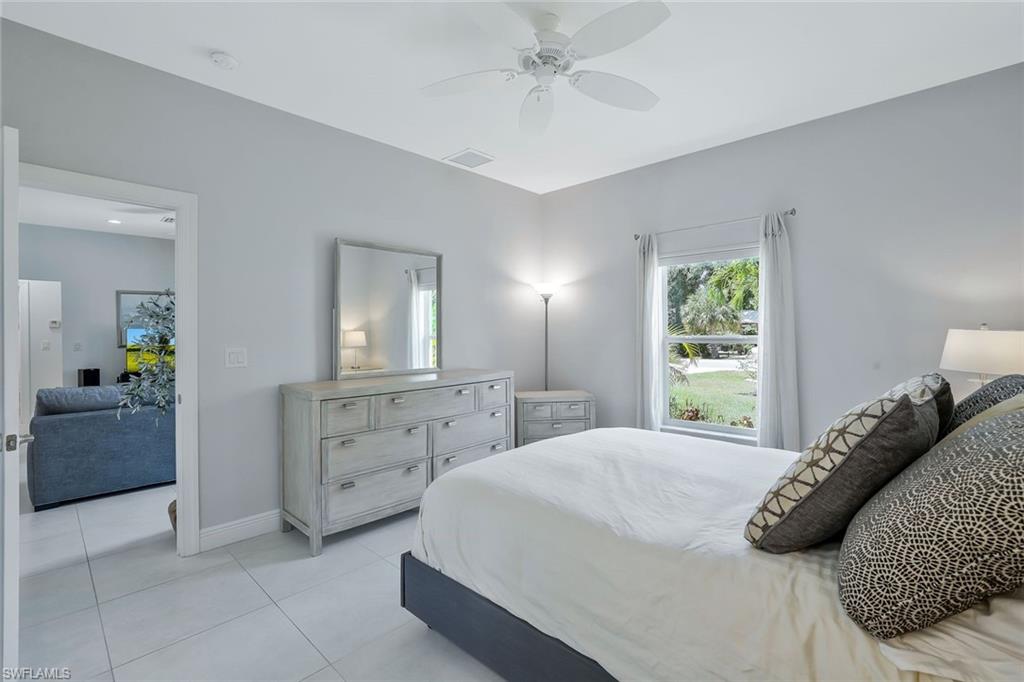 3892 14th Street North Naples, FL 34103 - Photo 8 of 19 a bedroom with a bed and a dresser