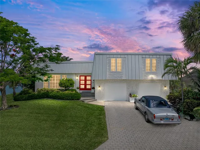 a view of an ocean with boats and trees in the background