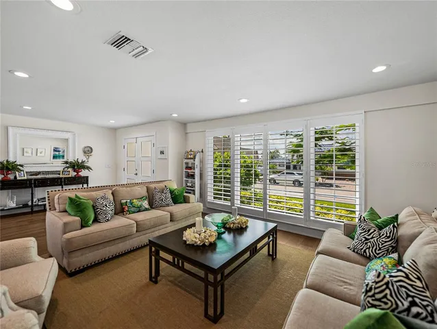 a living room with furniture and a floor to ceiling window