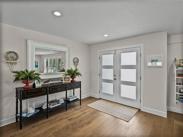 a kitchen with stainless steel appliances a stove a sink and a white wooden cabinets