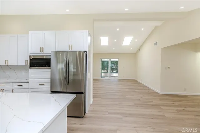 a kitchen with stainless steel appliances a refrigerator and a stove