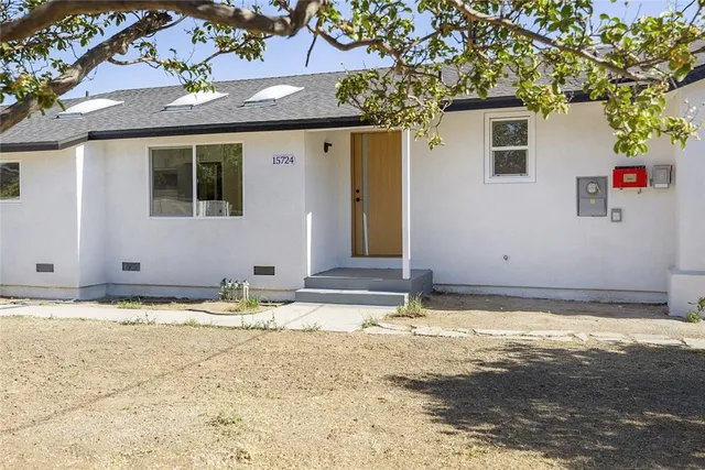 a view of a house with pool and a tree