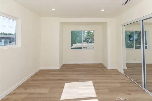 a bathroom with a toilet sink vanity granite and shower