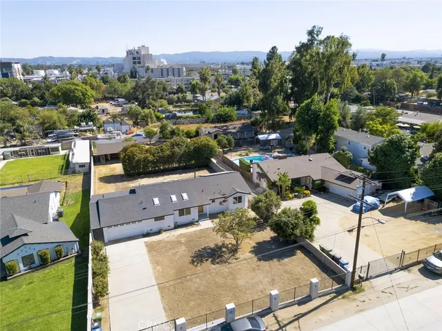 an aerial view of a house with a yard and lake view