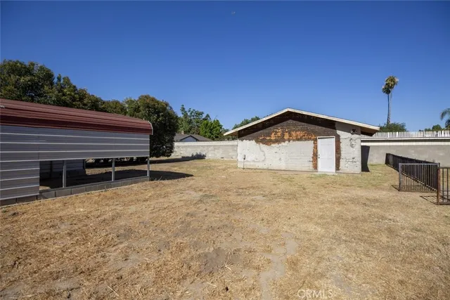 a view of a pathway with a wrought fence