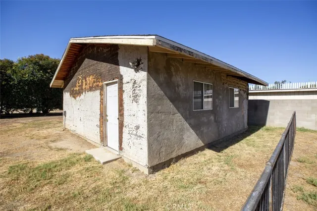 a big house with a big yard and large trees