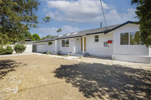 a big house with a big yard and large trees
