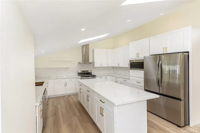 a kitchen with a white refrigerator a sink and a stove