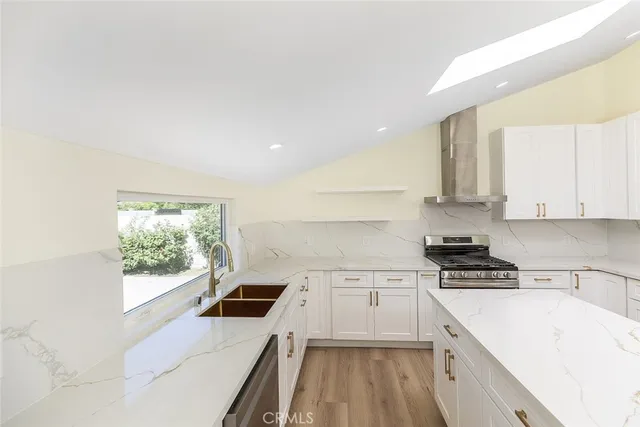 a kitchen with a white stove top oven and sink