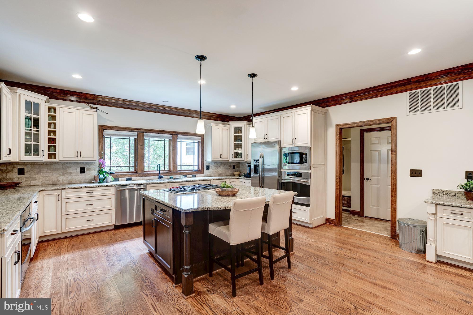 1020 Aponi Road Southeast Vienna, VA 22180 - Photo 11 of 64 center island with stools and pendent lighting