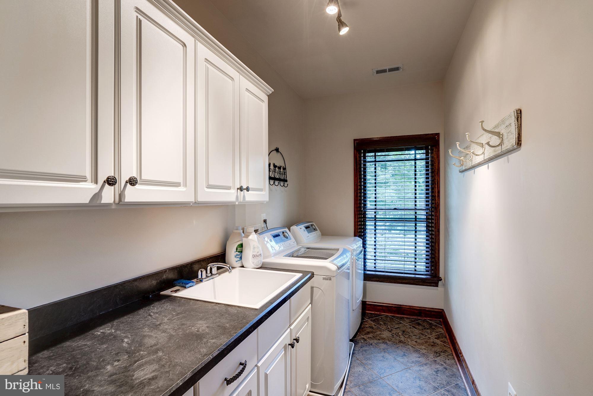 1020 Aponi Road Southeast Vienna, VA 22180 - Photo 41 of 64 upper level laundry room with sink and cabs