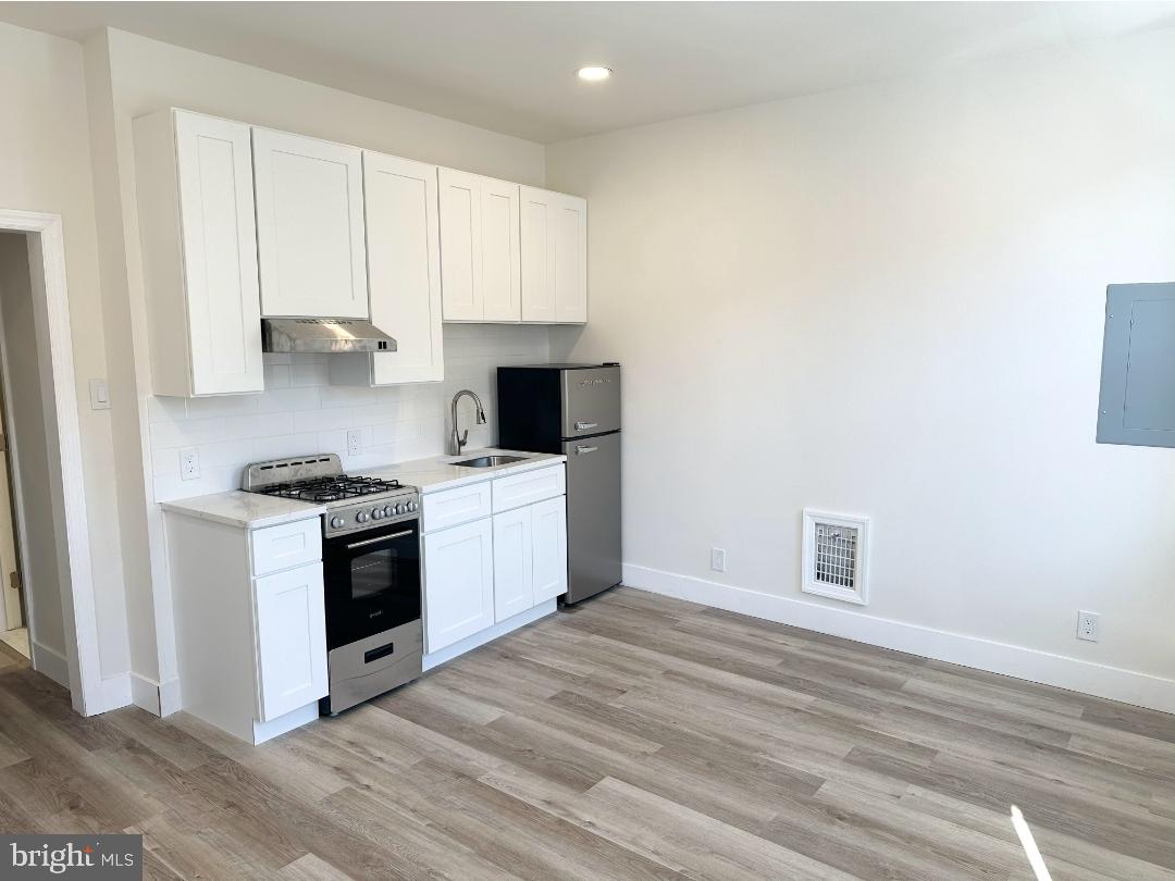 1532 South 2nd Street, Unit 2F Philadelphia, PA 19147 - Photo 4 of 19 a kitchen with white cabinets and white appliances