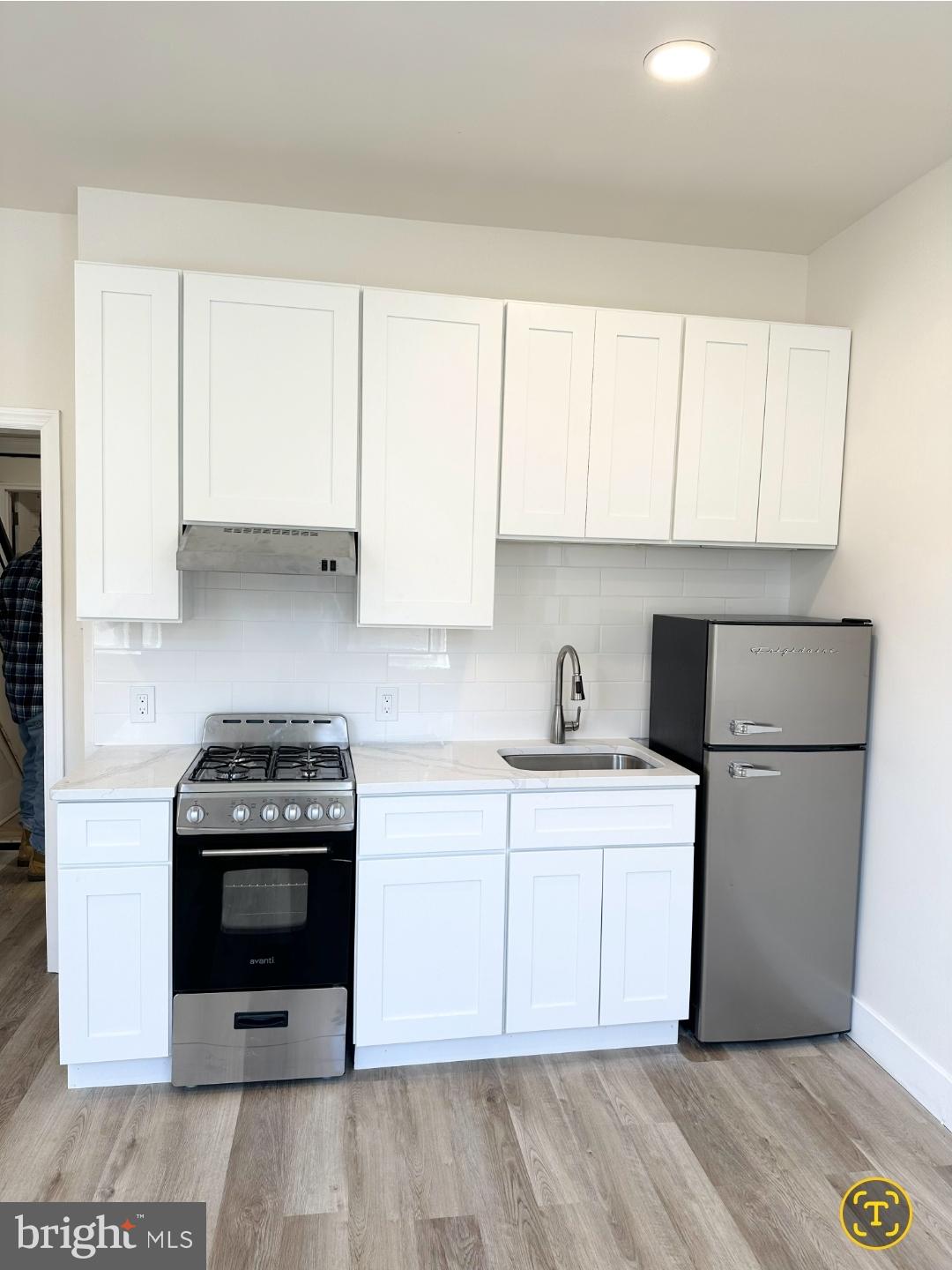 1532 South 2nd Street, Unit 2F Philadelphia, PA 19147 - Photo 5 of 19 a kitchen with a stove a sink and a refrigerator