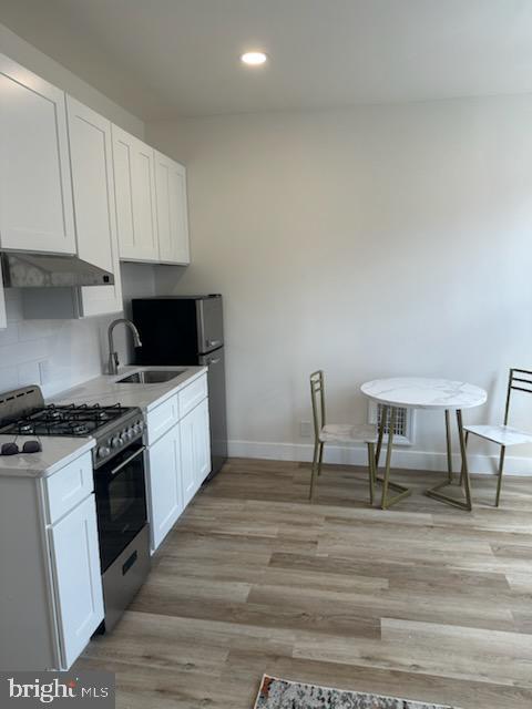 1532 South 2nd Street, Unit 2F Philadelphia, PA 19147 - Photo 6 of 19 a kitchen with cabinets table and chairs