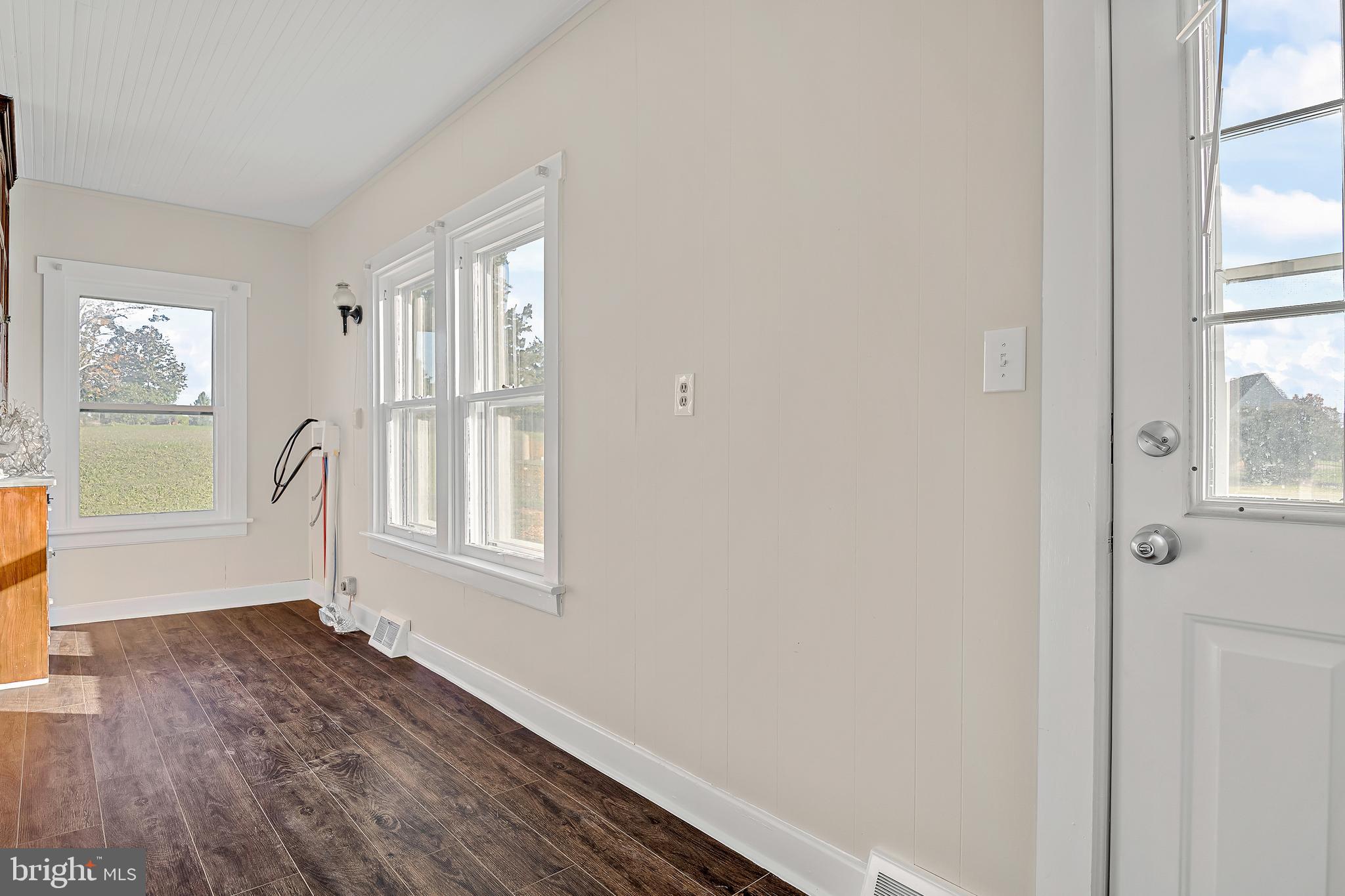 206 Hershey Road Hummelstown, PA 17036 - Photo 12 of 26 a view of an empty room with wooden floor and a window