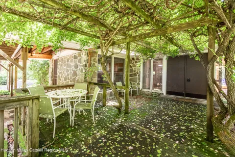 a backyard of a house with table and chairs