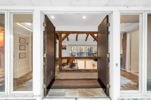 a view of a room with wooden floor and windows