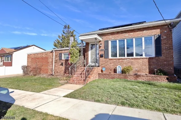 a front view of a house with a garden and patio