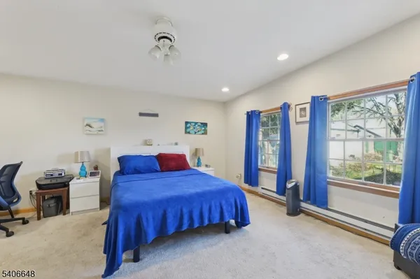 a bedroom with a bed and a large window