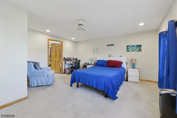 a spacious bedroom with a bed and a couch