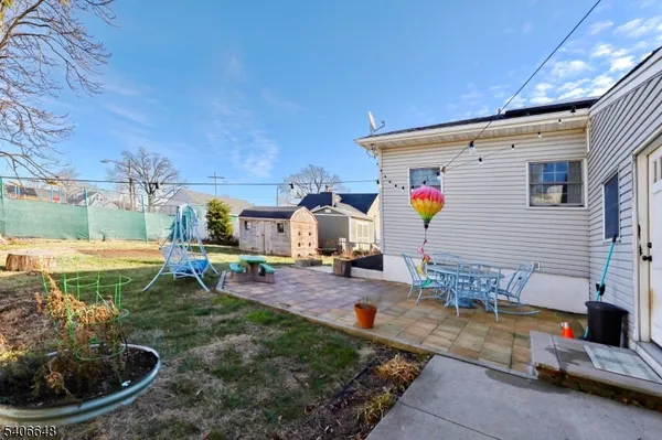 a view of a backyard with a patio and fire pit