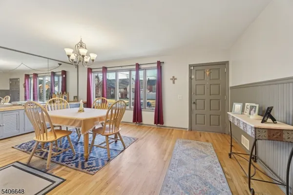 a view of a dining room with furniture and chandelier