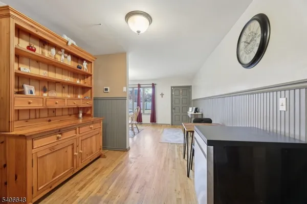 a kitchen with stainless steel appliances granite countertop a stove and a wooden floors