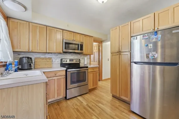 a kitchen with stainless steel appliances granite countertop a refrigerator stove and a sink