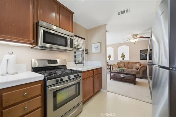 a kitchen with stainless steel appliances a stove a microwave and cabinets