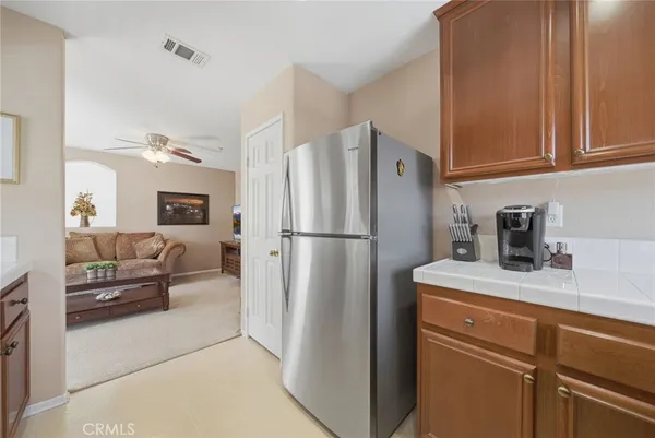a kitchen with a refrigerator a sink and cabinets