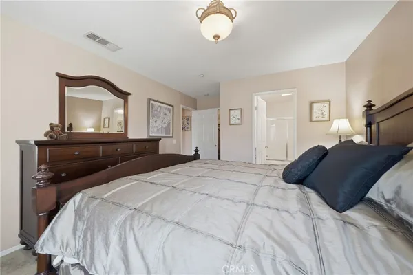 a bedroom with a bed and a mirror