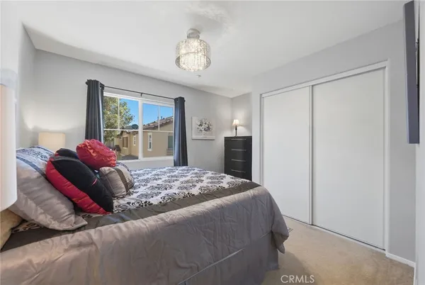 a bed room with a bed and a chandelier