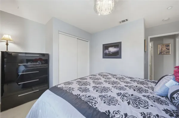 a bedroom with a bed and a dresser