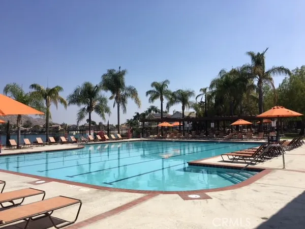 a view of a swimming pool with lounge chairs