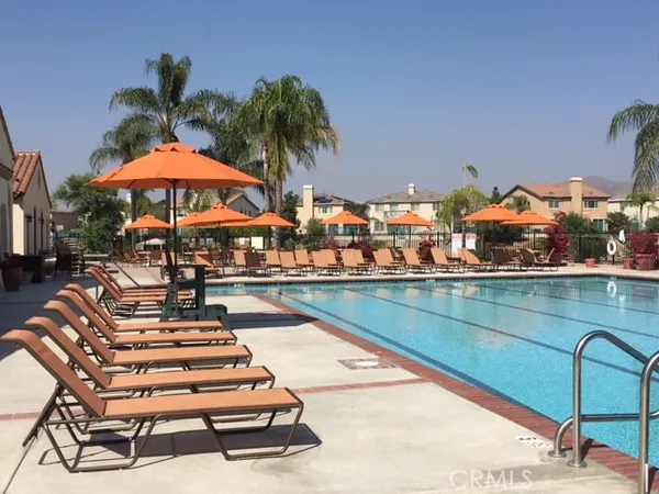a swimming pool with outdoor seating and yard