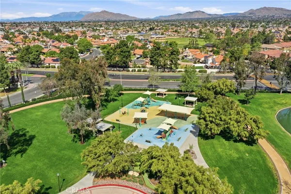 an aerial view of residential houses with outdoor space and street view