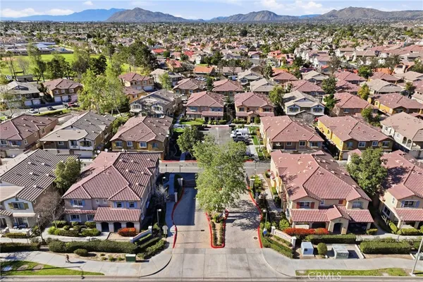 an aerial view of multiple houses with a mountain