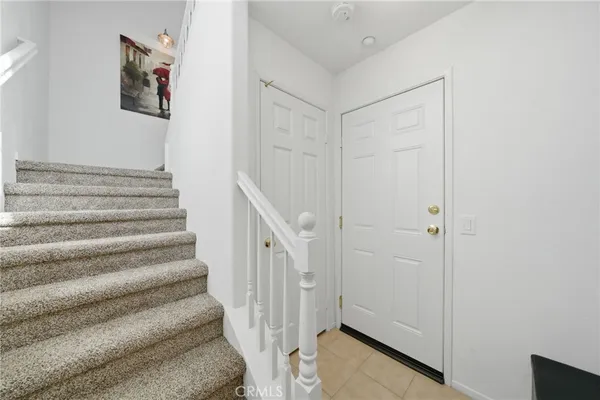 a view of a hallway with wooden floor and entryway