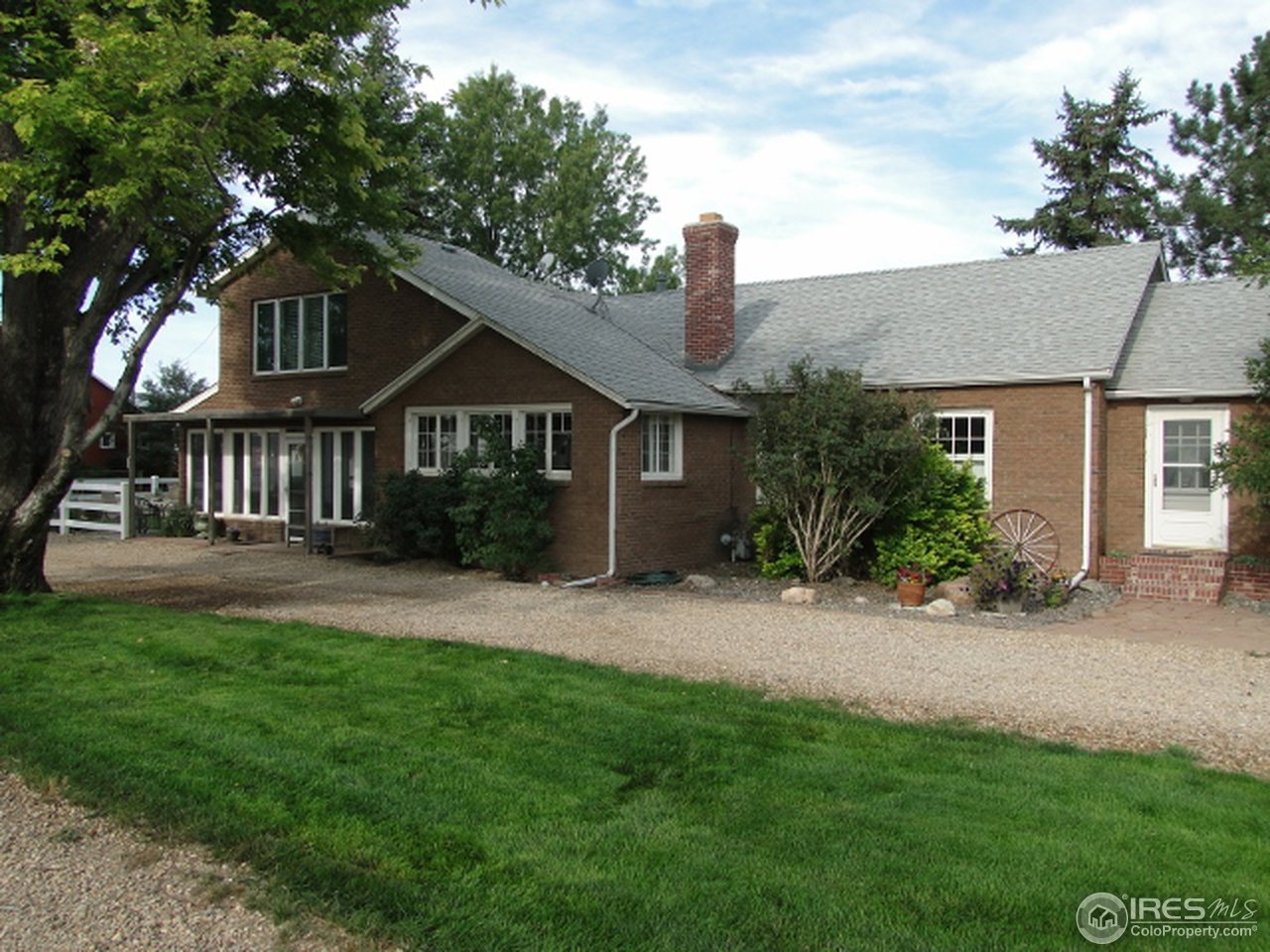 9268 County Road 28 Fort Lupton, CO 80621 - Photo 1 of 25 a front view of a house with a garden and yard