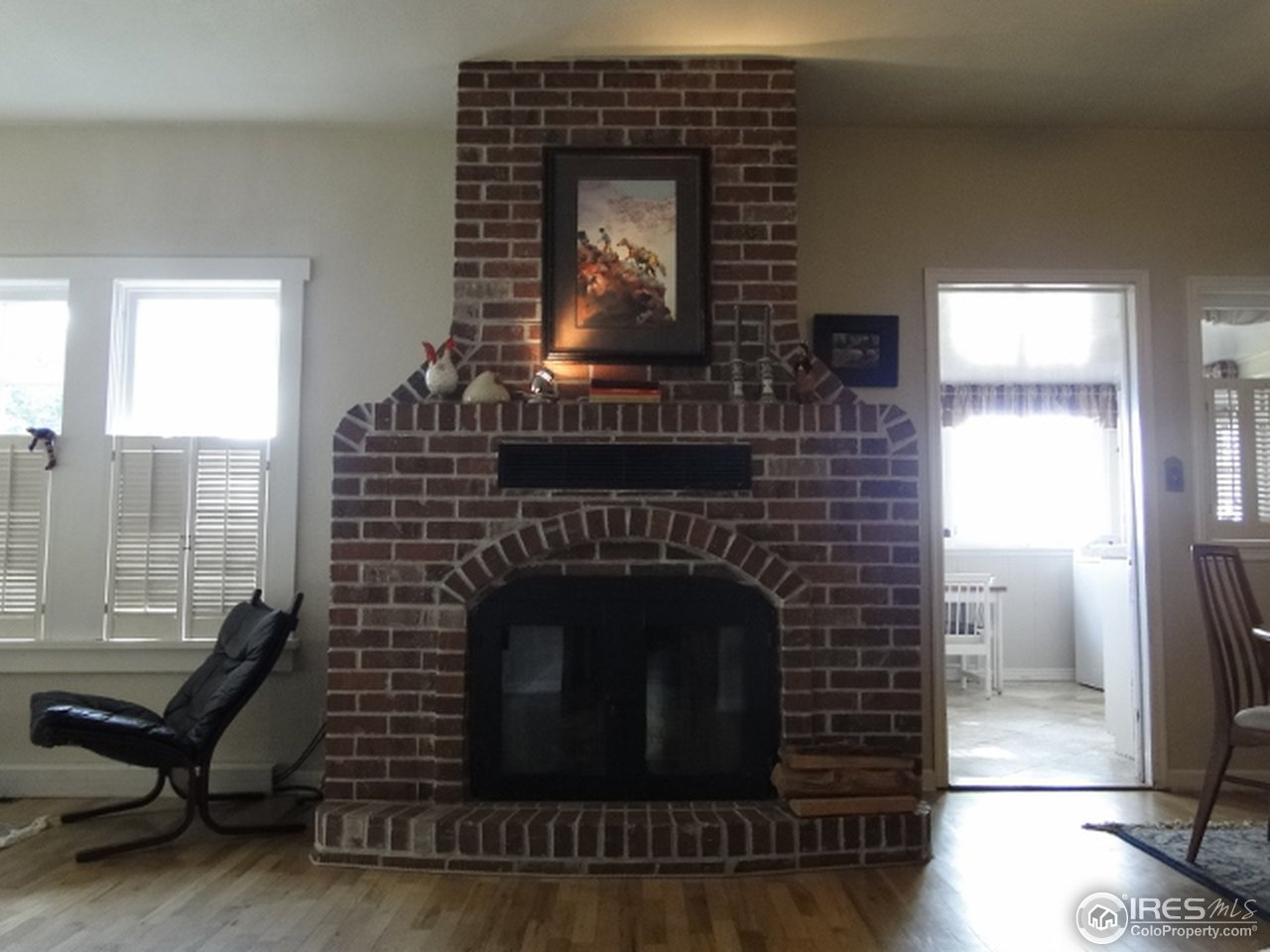 9268 County Road 28 Fort Lupton, CO 80621 - Photo 15 of 25 a living room with furniture and a fireplace