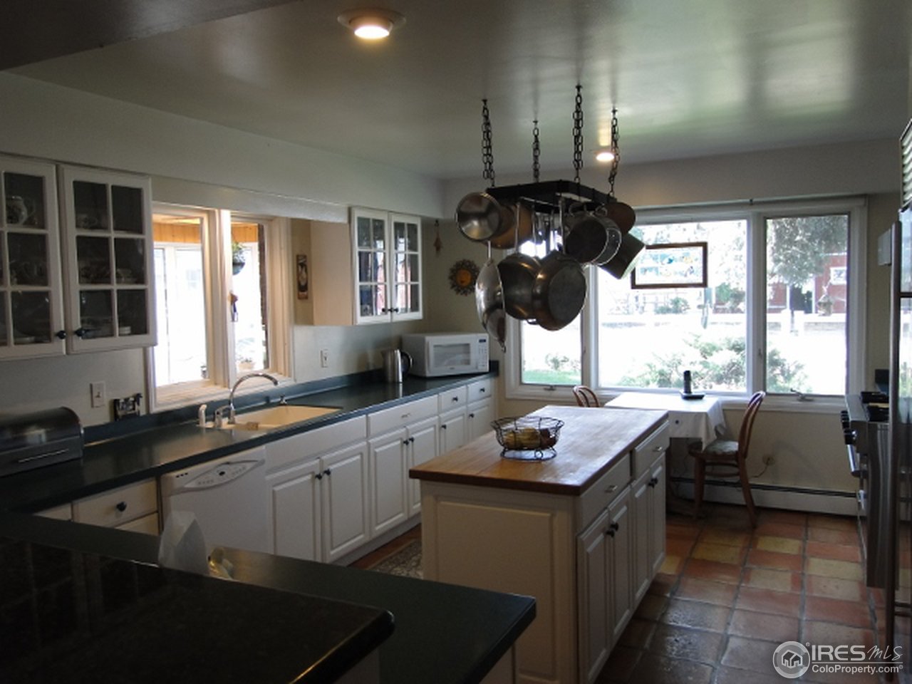 9268 County Road 28 Fort Lupton, CO 80621 - Photo 16 of 25 a kitchen with a sink cabinets and window