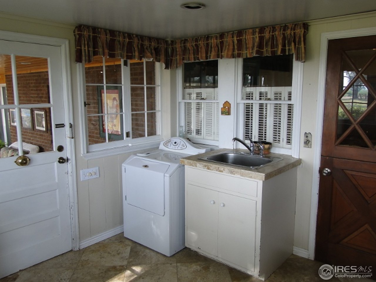 9268 County Road 28 Fort Lupton, CO 80621 - Photo 21 of 25 a view of living room with furniture and washer