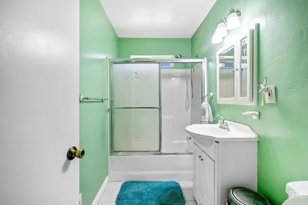 a bathroom with a sink mirror and toilet