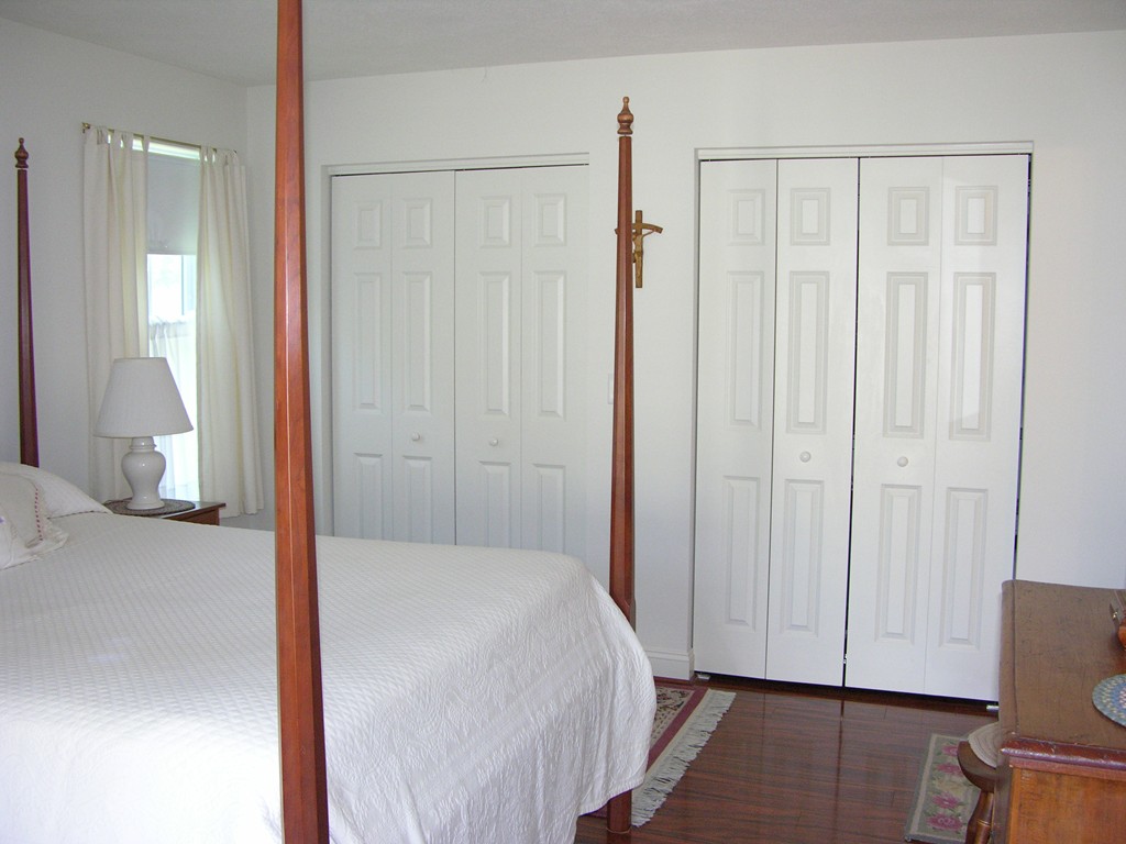 96 Hall Road, Unit 96 Fremont, NH 03044 - Photo 18 of 26 a view of a room with wooden floor and cabinet