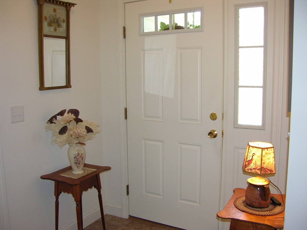 96 Hall Road, Unit 96 Fremont, NH 03044 - Photo 4 of 26 a view of entryway with livingroom and chandelier