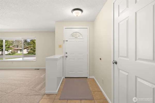 a view of a hallway view with wooden floor and a bathroom