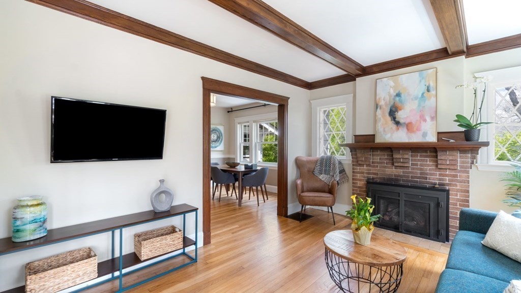 155 Marked Tree Road Needham, MA 02492 - Photo 8 of 34 a living room with furniture a flat screen tv and a fireplace