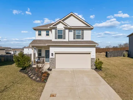 a front view of a house with a yard and garage